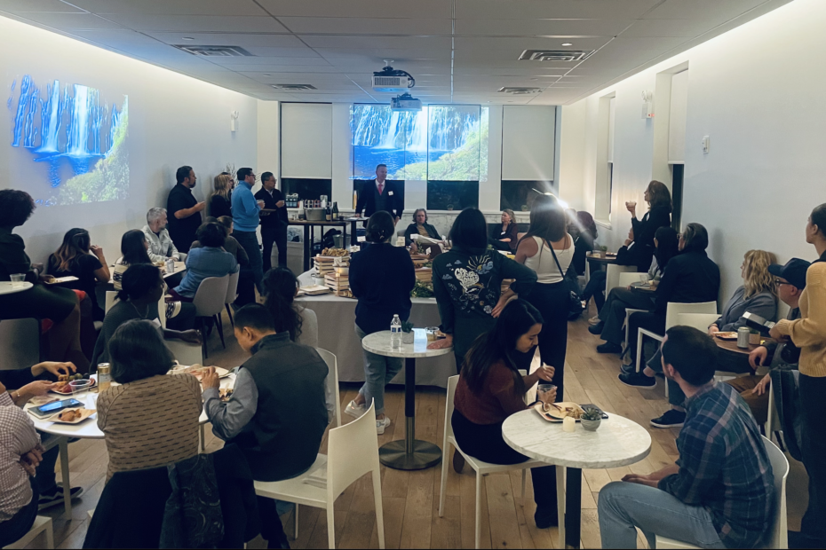 A beautifully lit room, filled with community, feasting and listening together